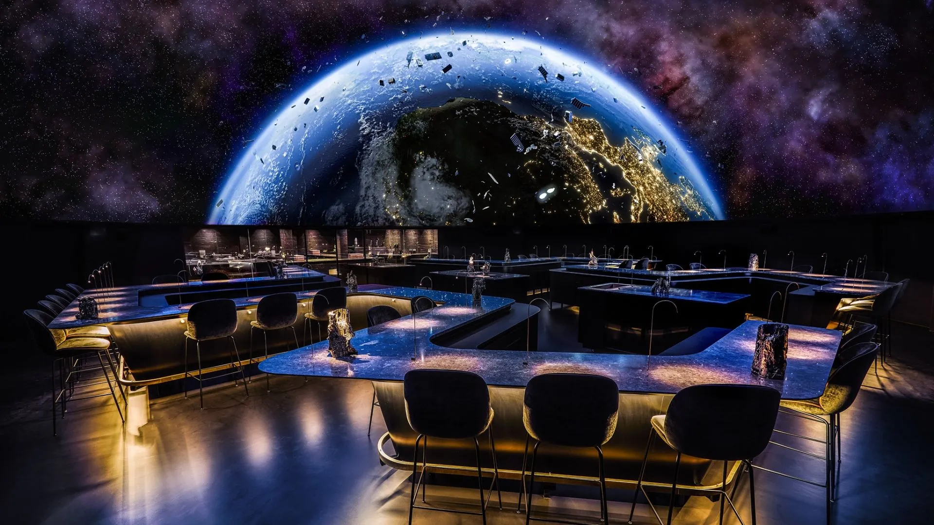 Futuristic immersive bar counter with a large projection of Planet Earth in space.